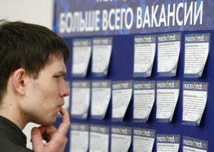 A man reads job offers posted at job fair in Moscow