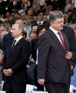 Ukraine's President-elect Petro Poroshenko walks past Russian President Vladimir Putin during the commemoration of the 70th anniversary of the D-Day in Ouistreham