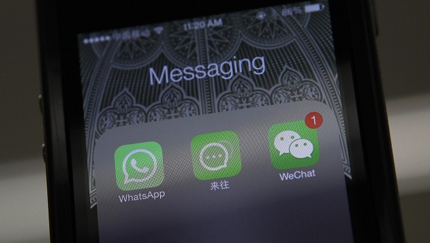 File photo illustration shows icons messaging WhatsApp, Laiwang and WeChat на экране smart phone in Beijing